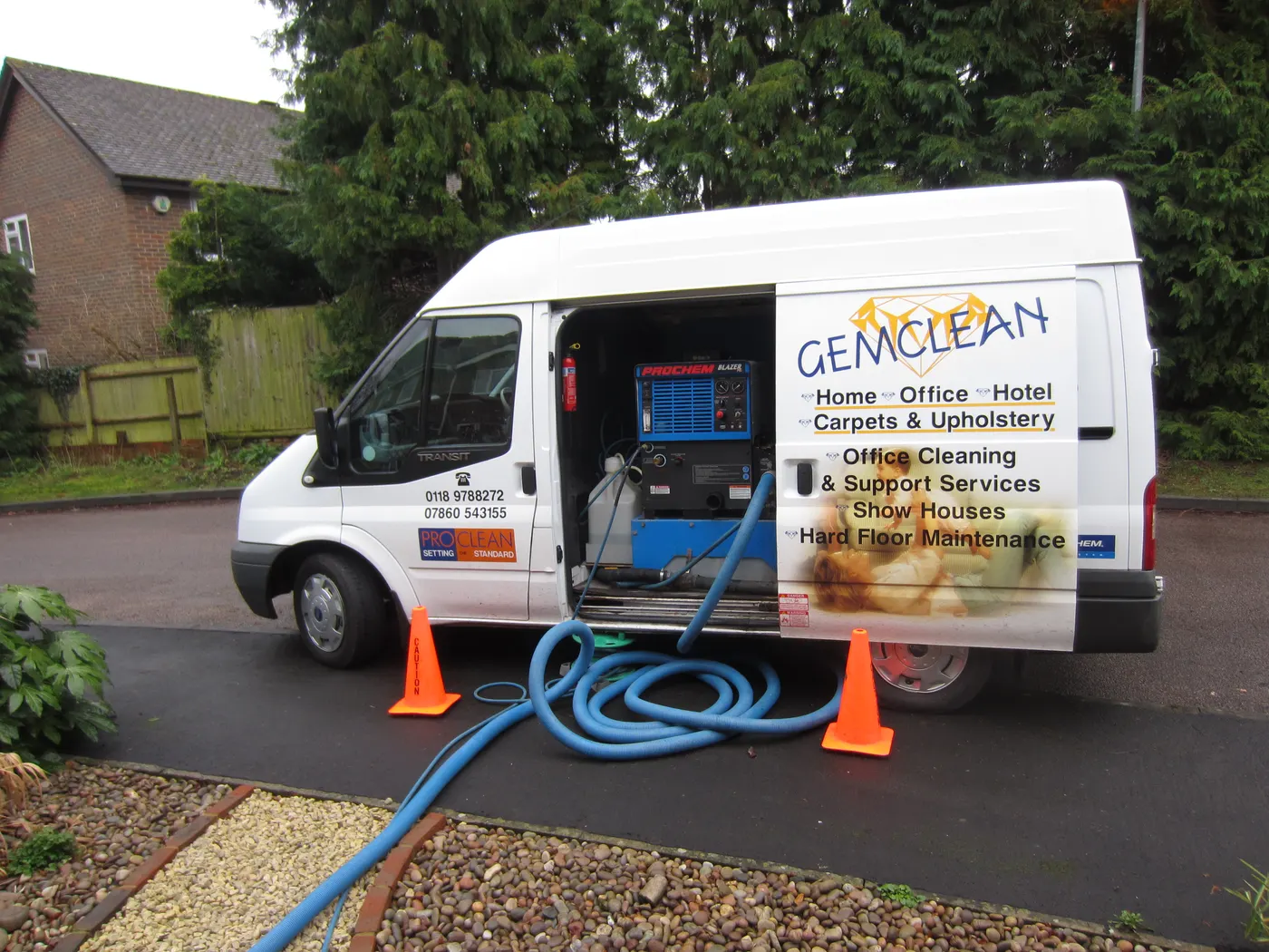 The Gemclean van on a driveway, side door open on the truck mount unit