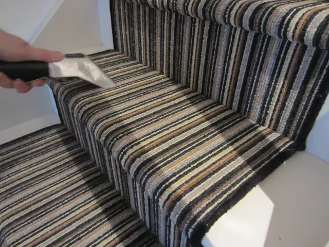 Cleaning a striped stair runner tread by tread