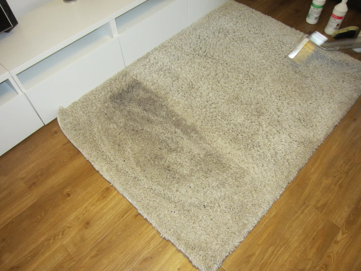 The same rug halfway through, the cleaned side next to the dirty one