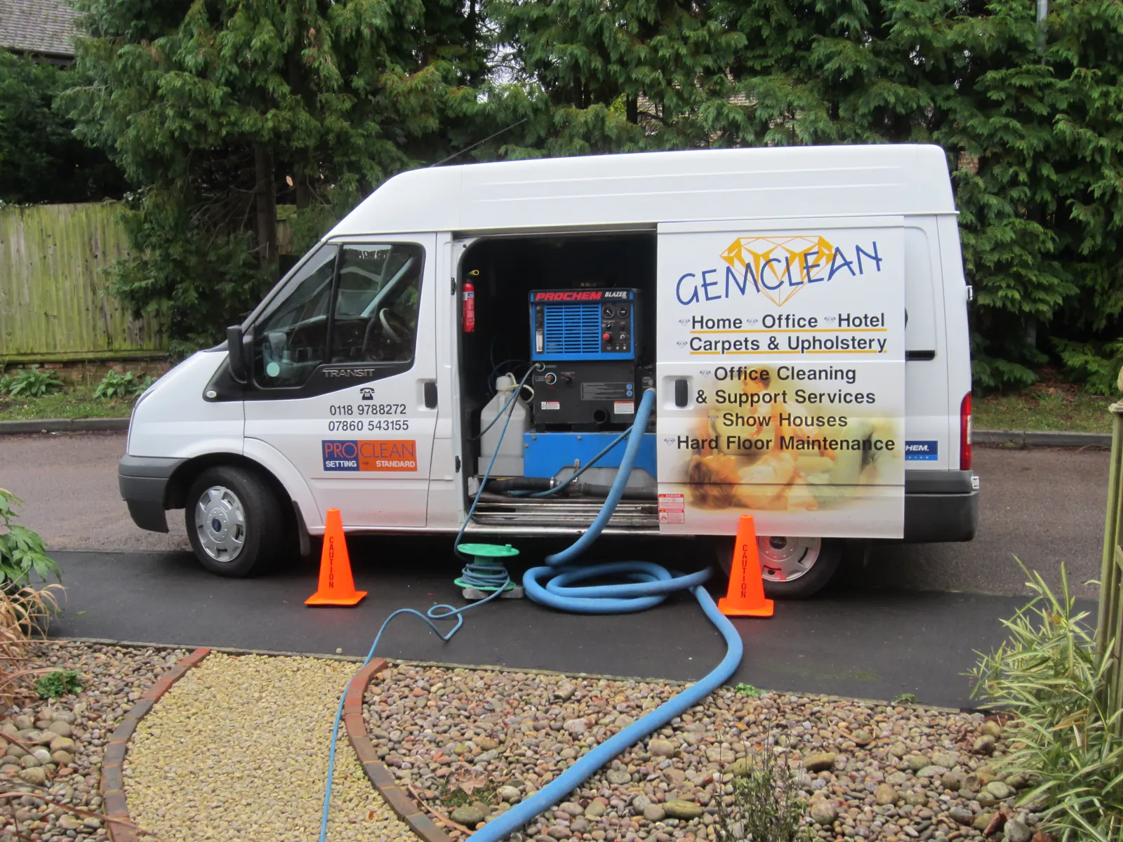 The Gemclean van on a driveway, truck mount hoses running up the garden path to the house